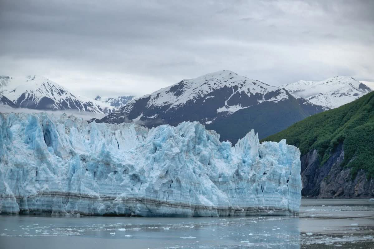 Tidewater glacier face with floating ice in Glacier Bay National Park, Alaska