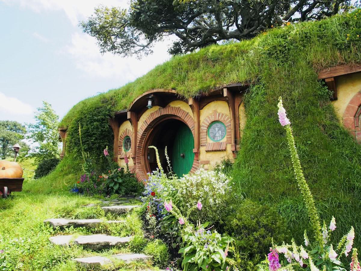 Round green door of a hobbit hole at the Hobbiton movie set, New Zealand