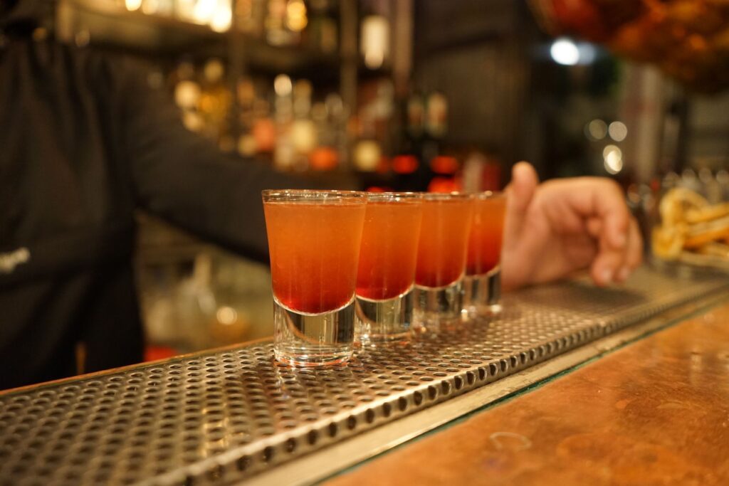 Colorful cocktail shots ready on a bar counter, capturing nightlife and bar atmosphere
