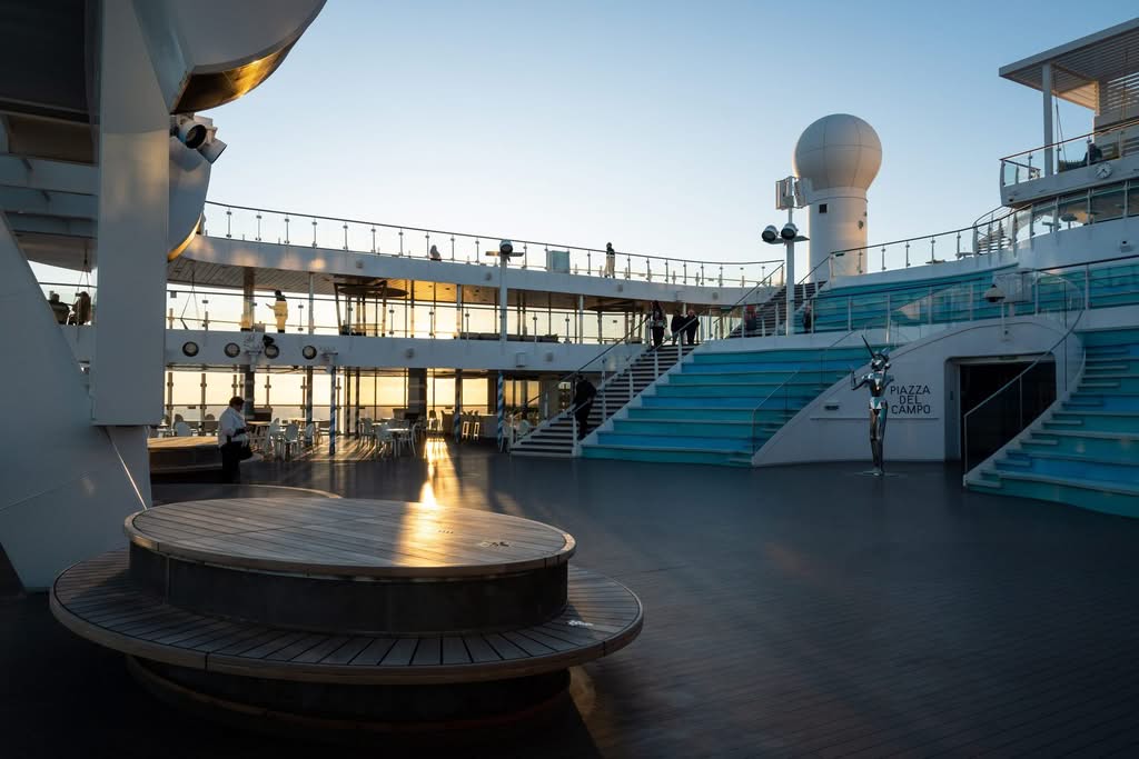 Elegant open-air deck on a premium cruise ship at sunset