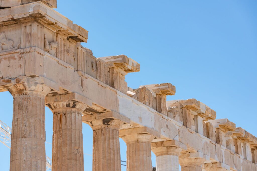 Close-up of the Parthenon columns in Athens, Greece, against a clear summer sky