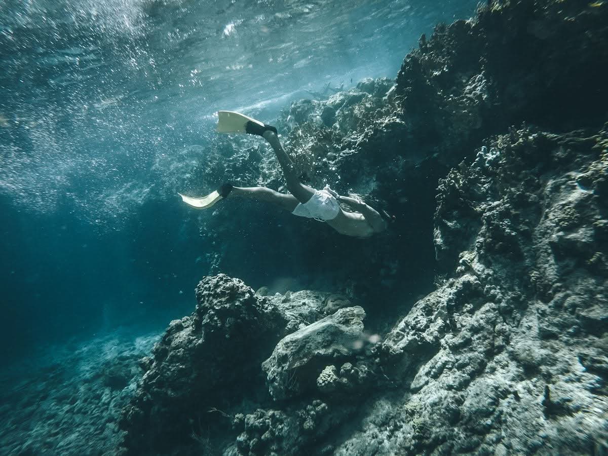 Snorkeler freediving over a Caribbean coral reef